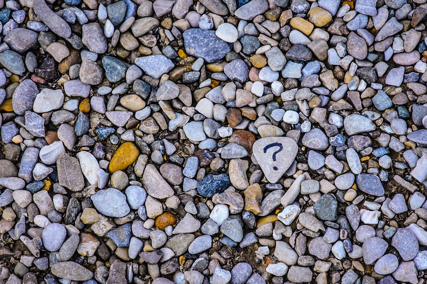 Pictures of stones, one stone with a question mark on it Pictures of stones, one stone with a question mark on it
