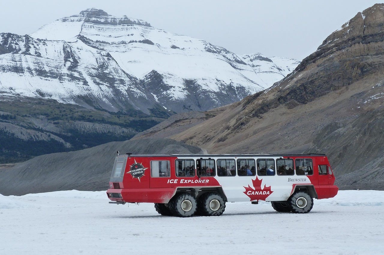 Ice Explorer vehicle on Athabasca Glacier at Columbia Icefield, specialized glacier tour for multi-generational groups in Jasper