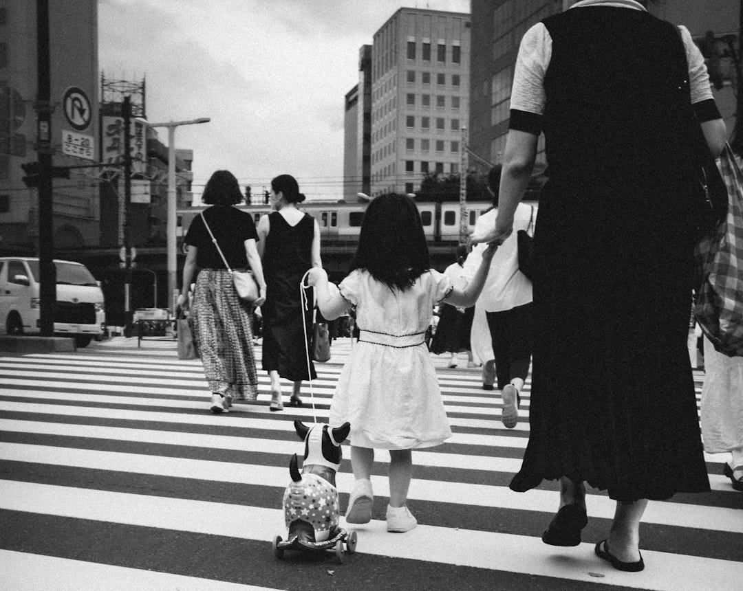 a little girl walking down the street