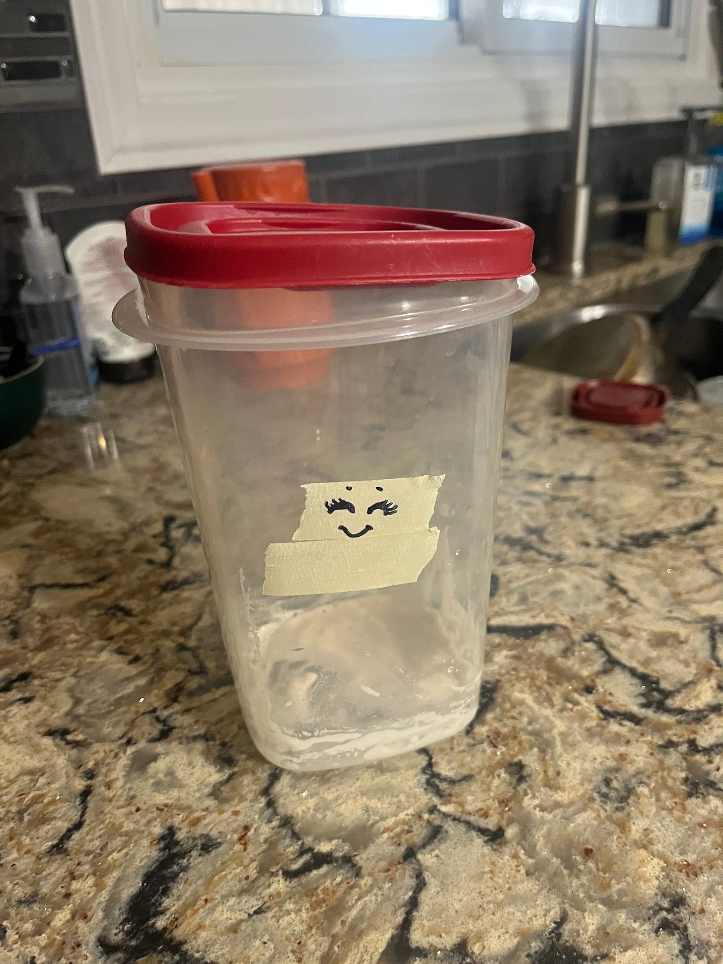 a nearly empty container of starter