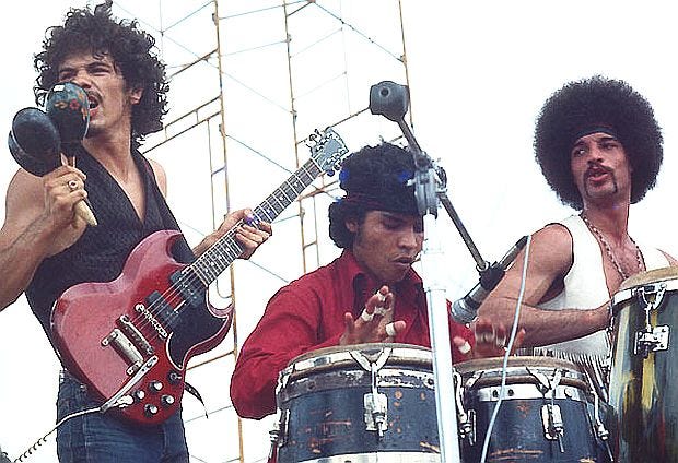 August 16, 1969. Carlos Santana, Jose Areas, and Michael Carabello during performance at Woodstock.