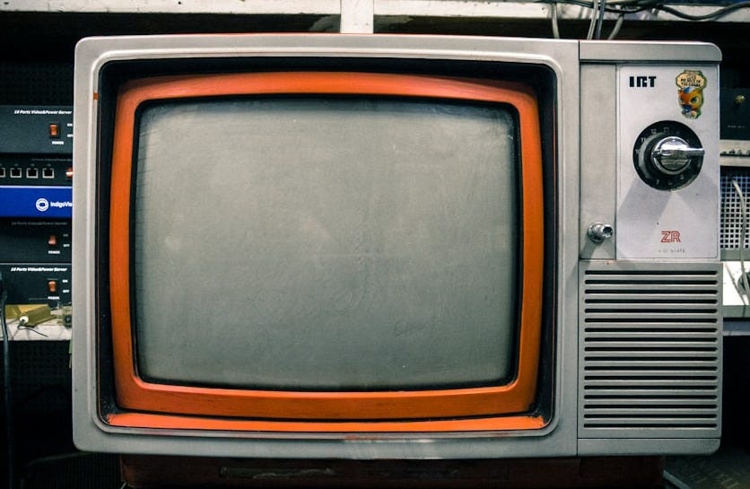 grey and orange CRT TV