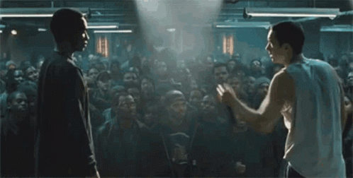 two men are standing in front of a crowd of people .