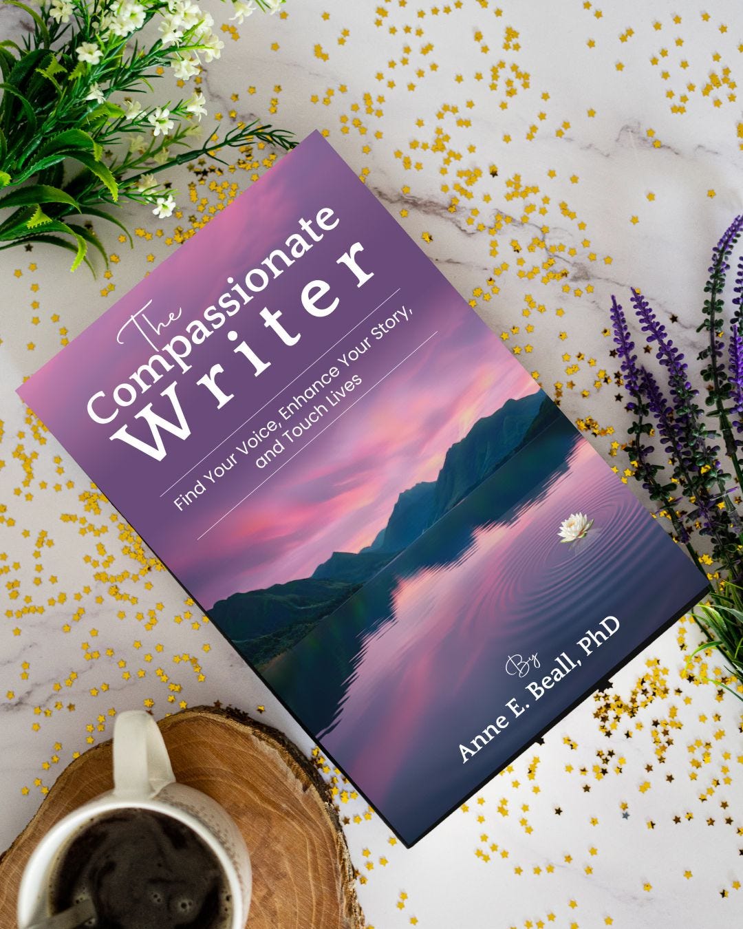 Book "The Compassionate Writer" next to flowers and cup of coffee