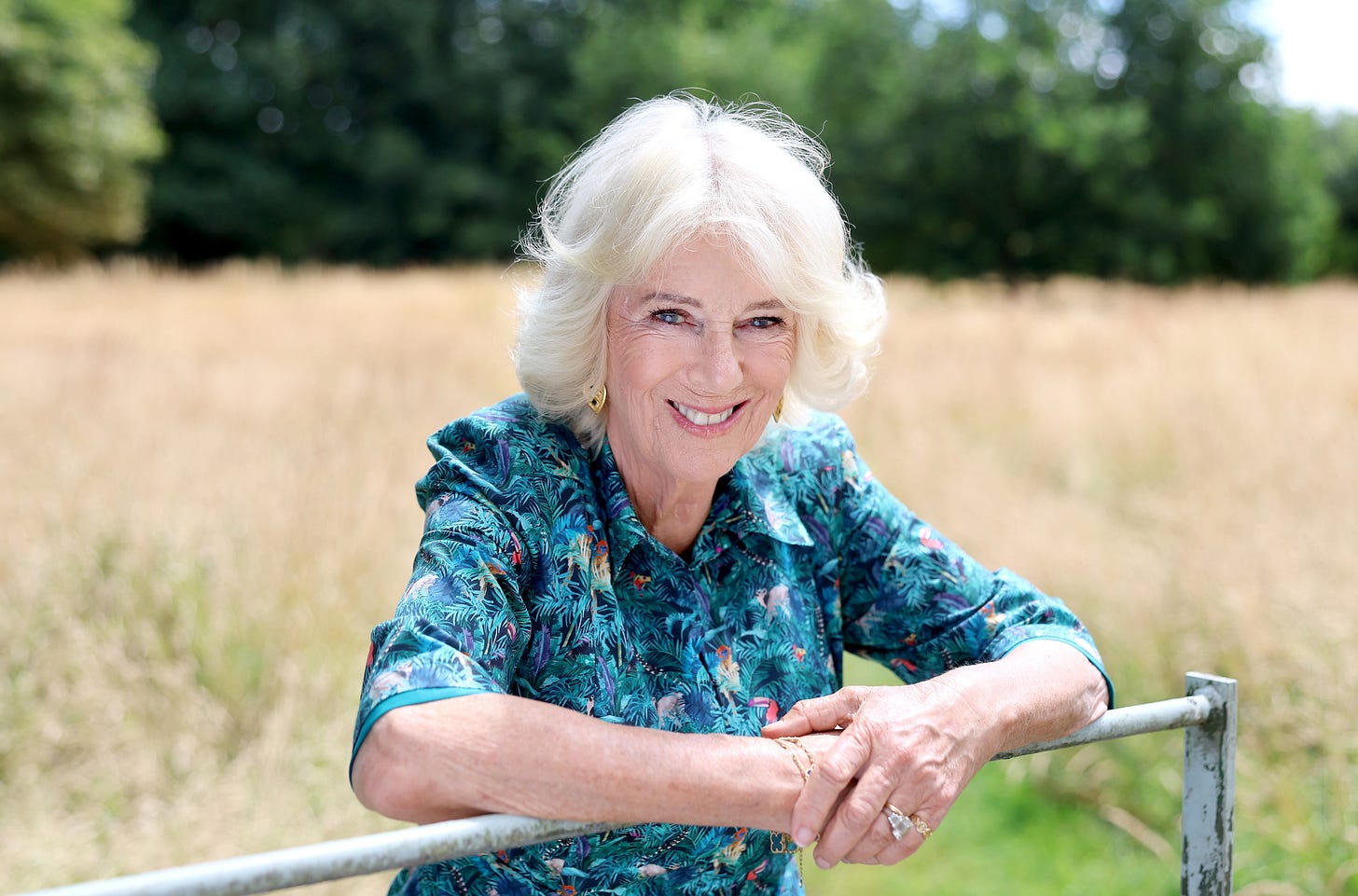 Queen Camilla leaning on a gate