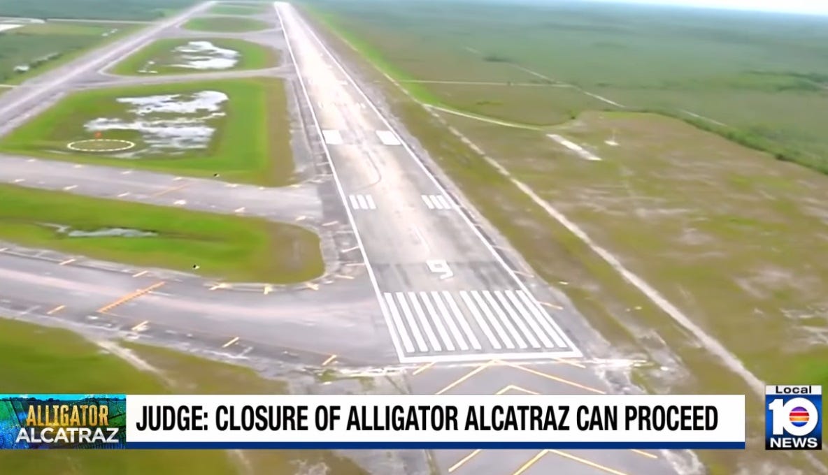 aerial footage of empty runways and taxiways in the Everglades, at the site that was later developed as a prison. Large pools of standing water can be seen between the paved areas. Chyron reads 'Judge: Closure of Alligator Alcatraz can proceed.' (an appeals court later stayed the order and the facility is still open) aerial footage of empty runways and taxiways in the Everglades, at the site that was later developed as a prison. Large pools of standing water can be seen between the paved areas. Chyron reads 'Judge: Closure of Alligator Alcatraz can proceed.' (an appeals court later stayed the order and the facility is still open)
