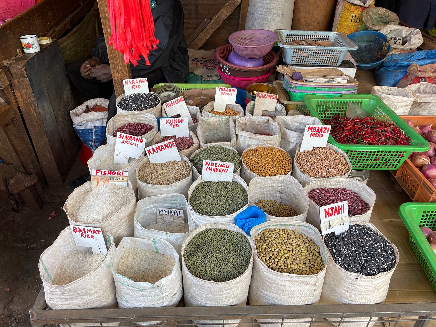 a market stall selling rice and legumes in neatly arranged sacks
