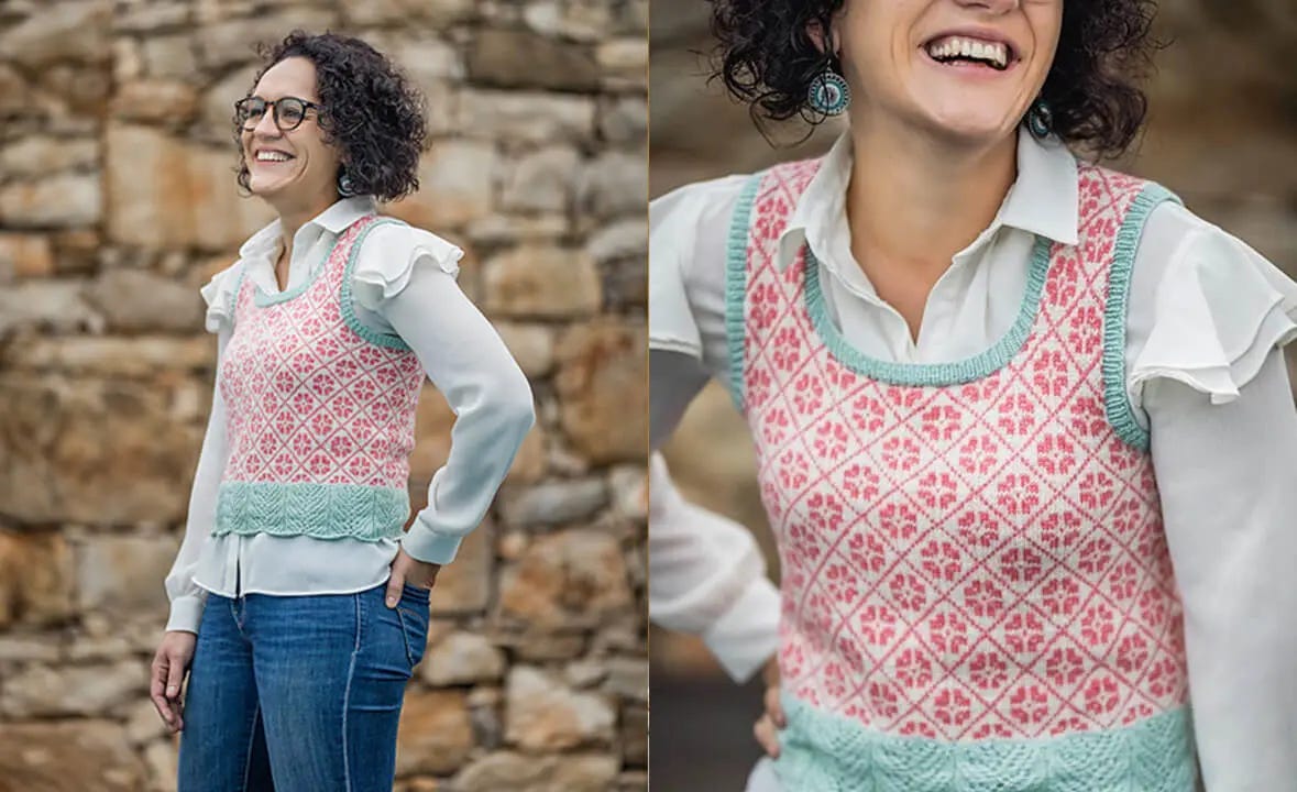 woman in front of stone wall smiling and wearing jeans, a white shirt and a colorwork vest