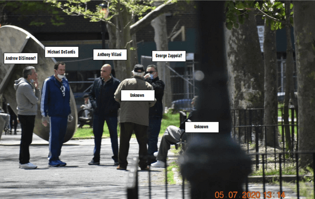 A group of people walking on a sidewalk

Description automatically generated