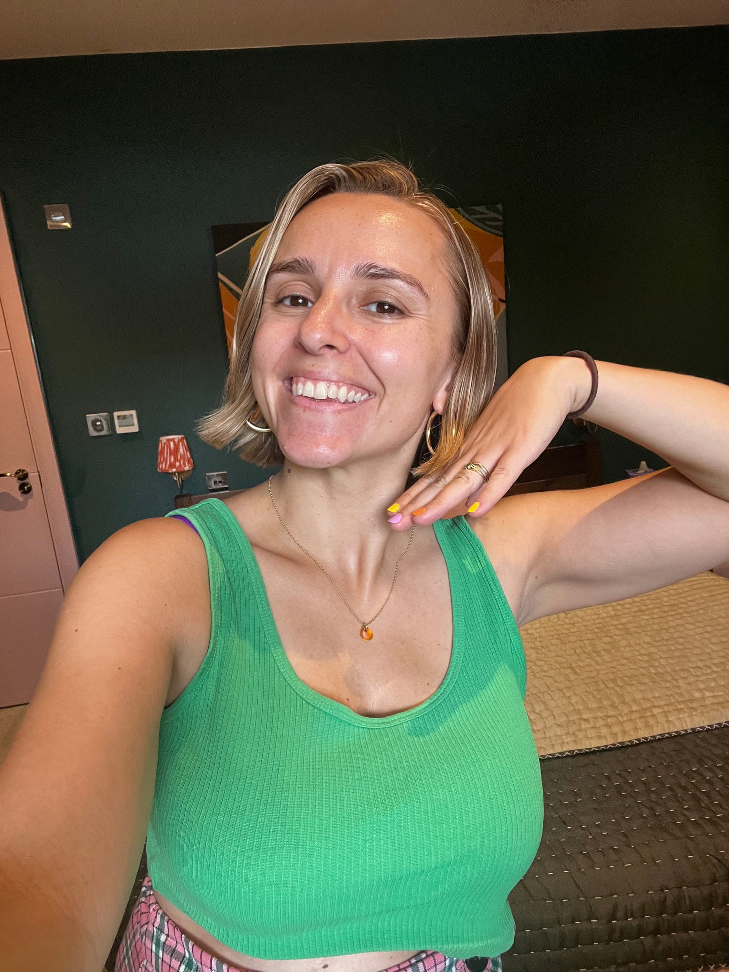 A selfie of Hannah smiling into the camera. Her hair is in a bob, just below her ears.