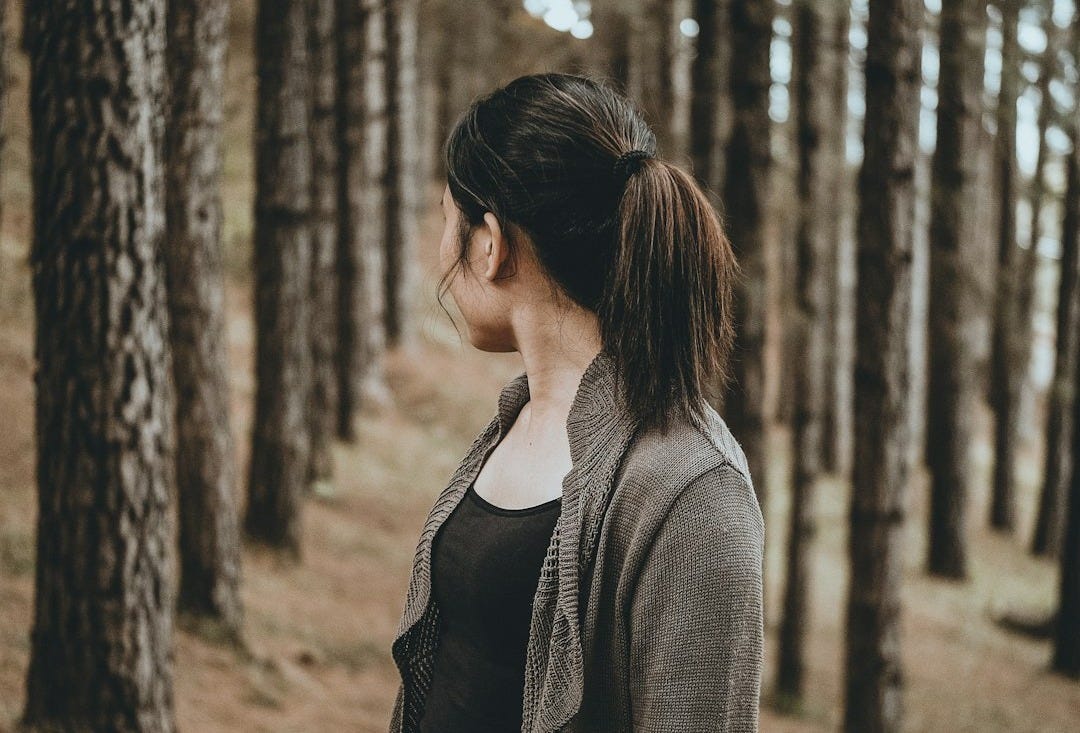 selective focus photography of woman looking back