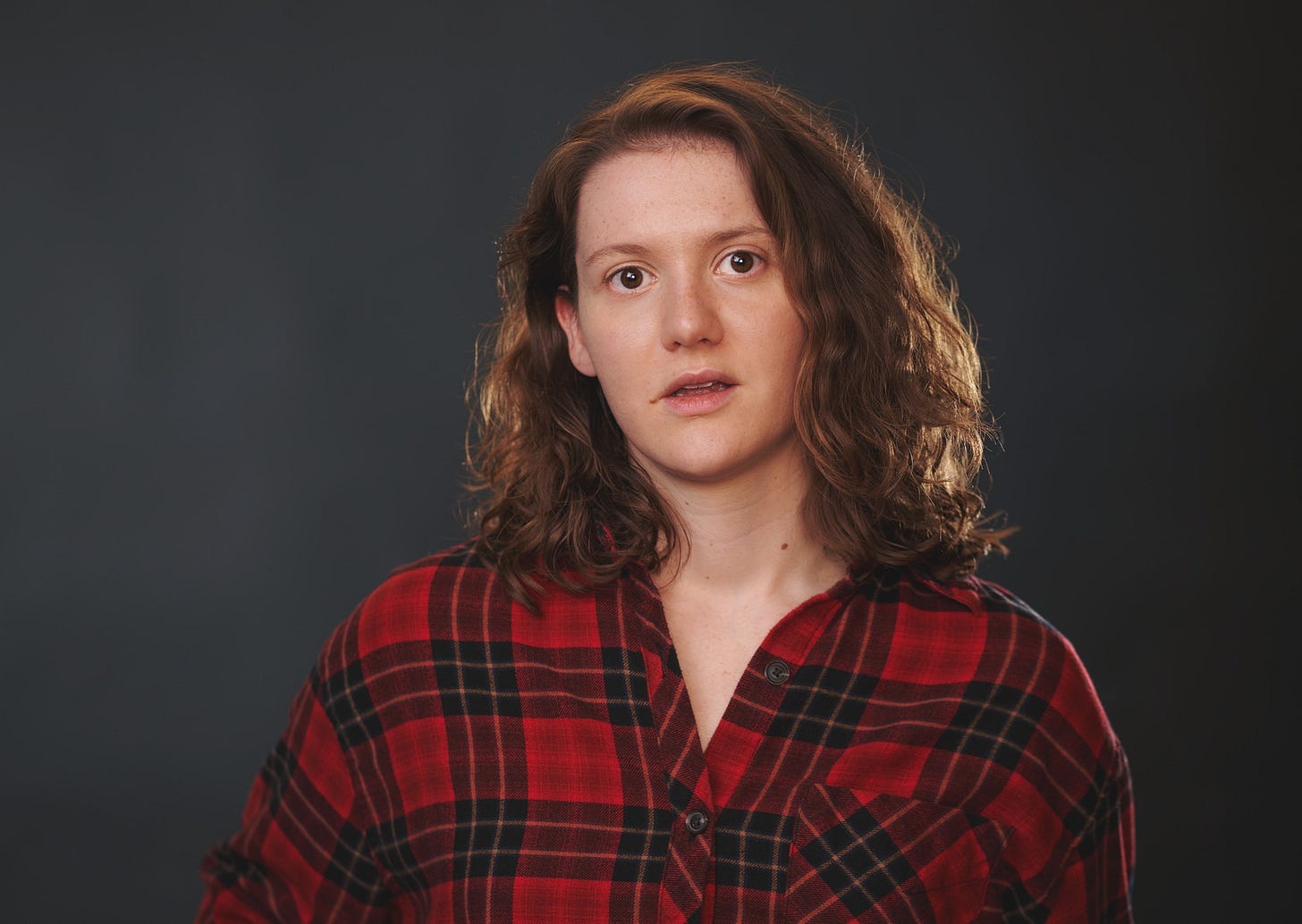 A close-up photo of Emily Ashberry. She has an expression on her face that suggest she was caught off-guard by the photographer.