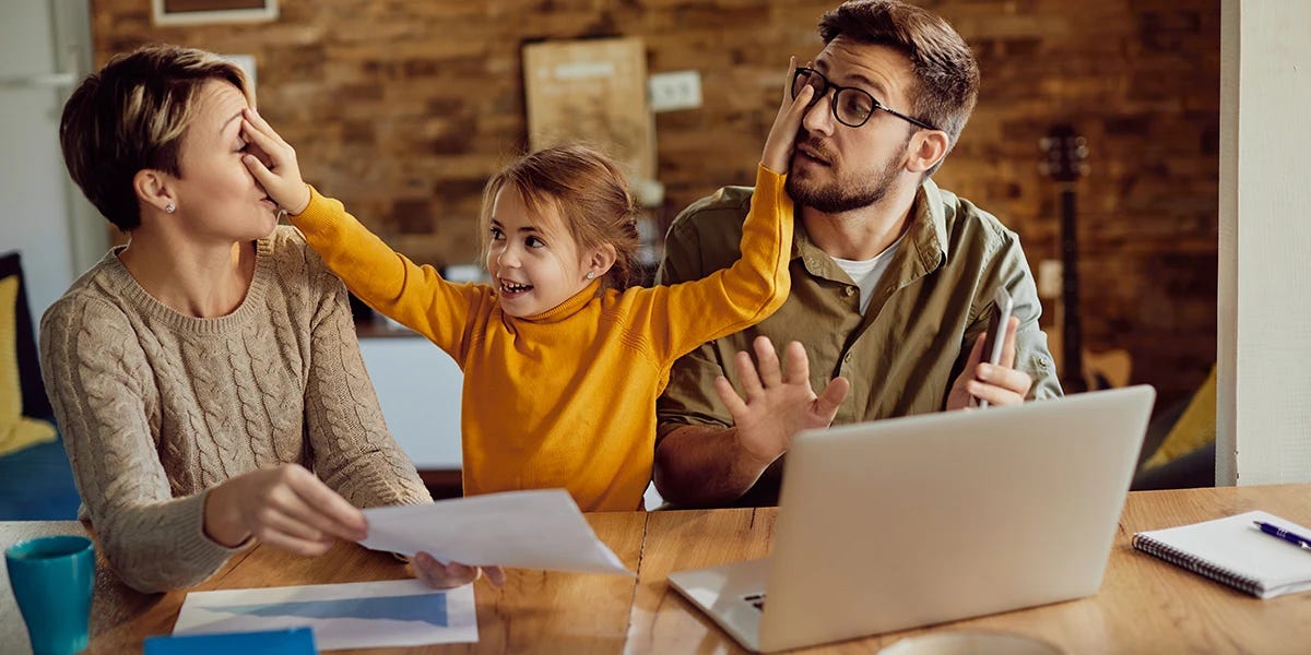 Spoiled child poking fingers into her parents' faces Spoiled child poking fingers into her parents' faces