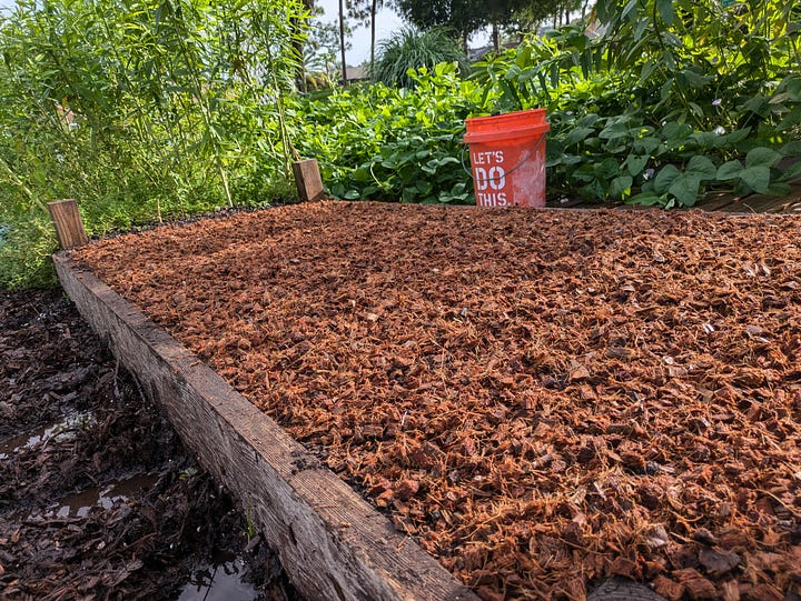 A series of four images showing the process of mixing soil amendments into a garden bed’s native soil. The first image shows the garden bed with amendments on top, the second shows the soil spread evenly, the third is a close-up of the amended soil in a bucket, and the fourth highlights fertilizer mixed into the top layer of soil.