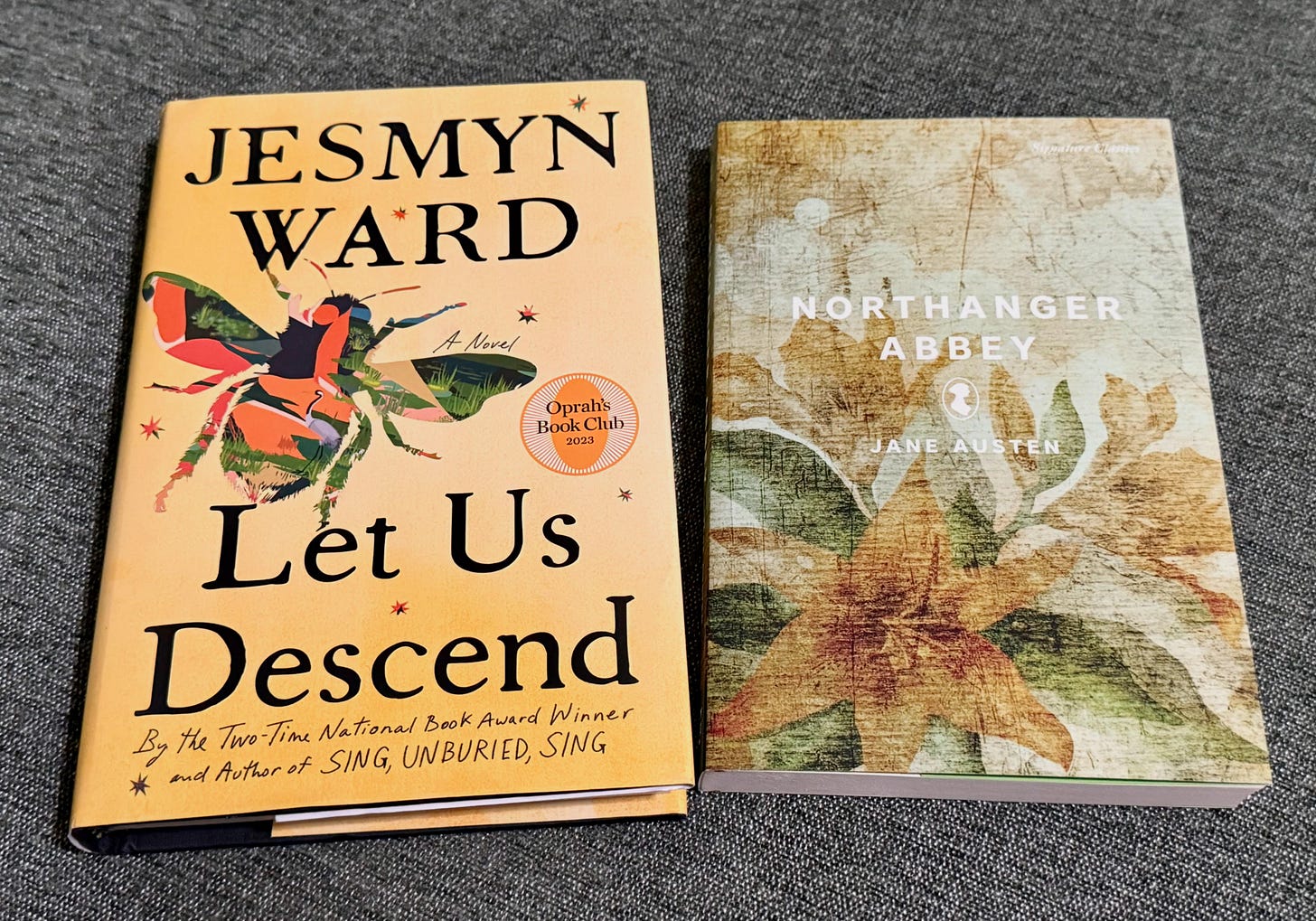 Two books on grey cloth.