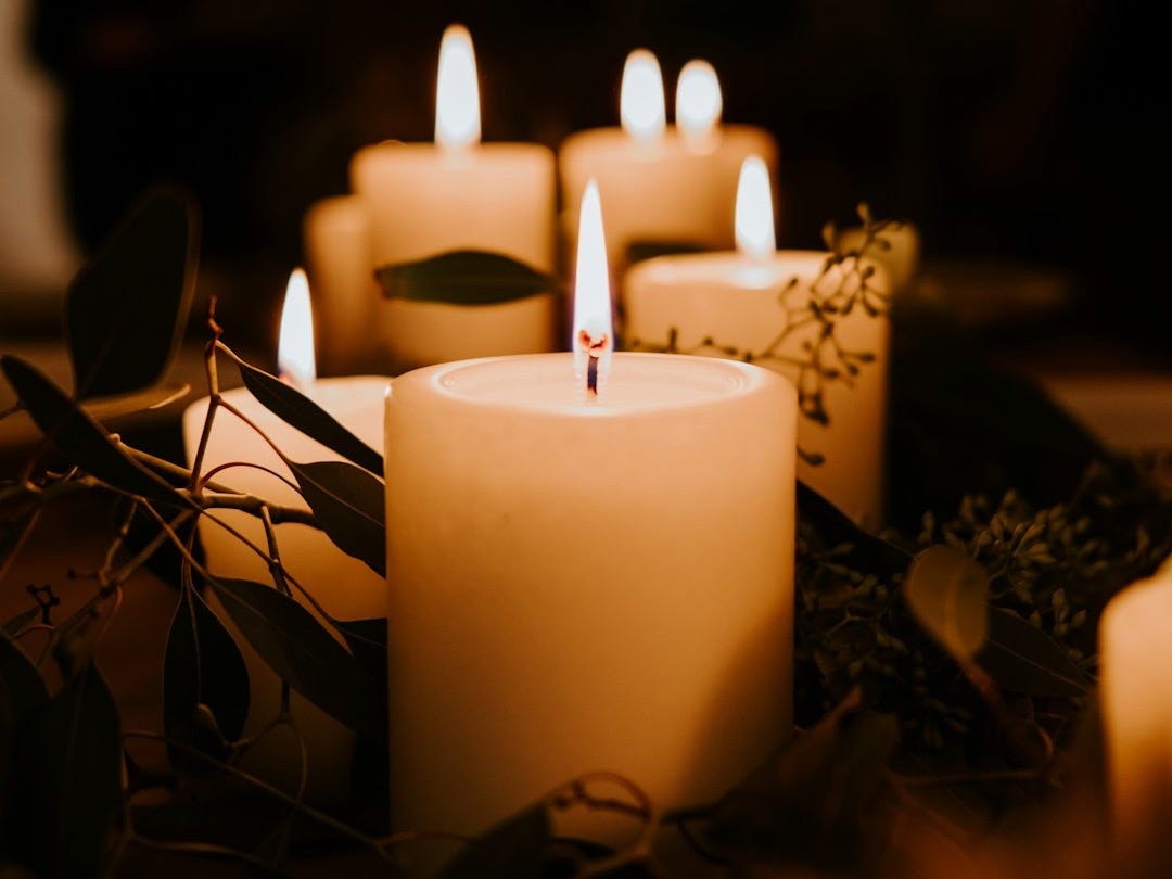 white pillar candles on black holder
