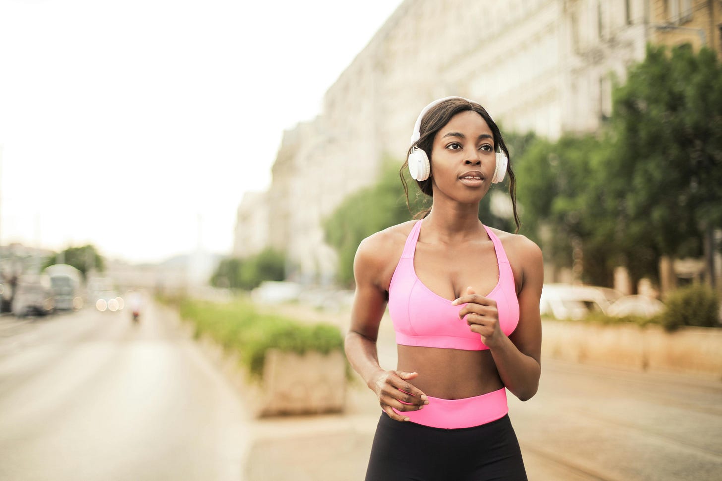 Woman in Pink Sports Bra and Black Leggings Jogging · Free Stock Photo