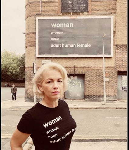Kellie-Jay Keen standing in front of her 2018 billboard Adult Human Female