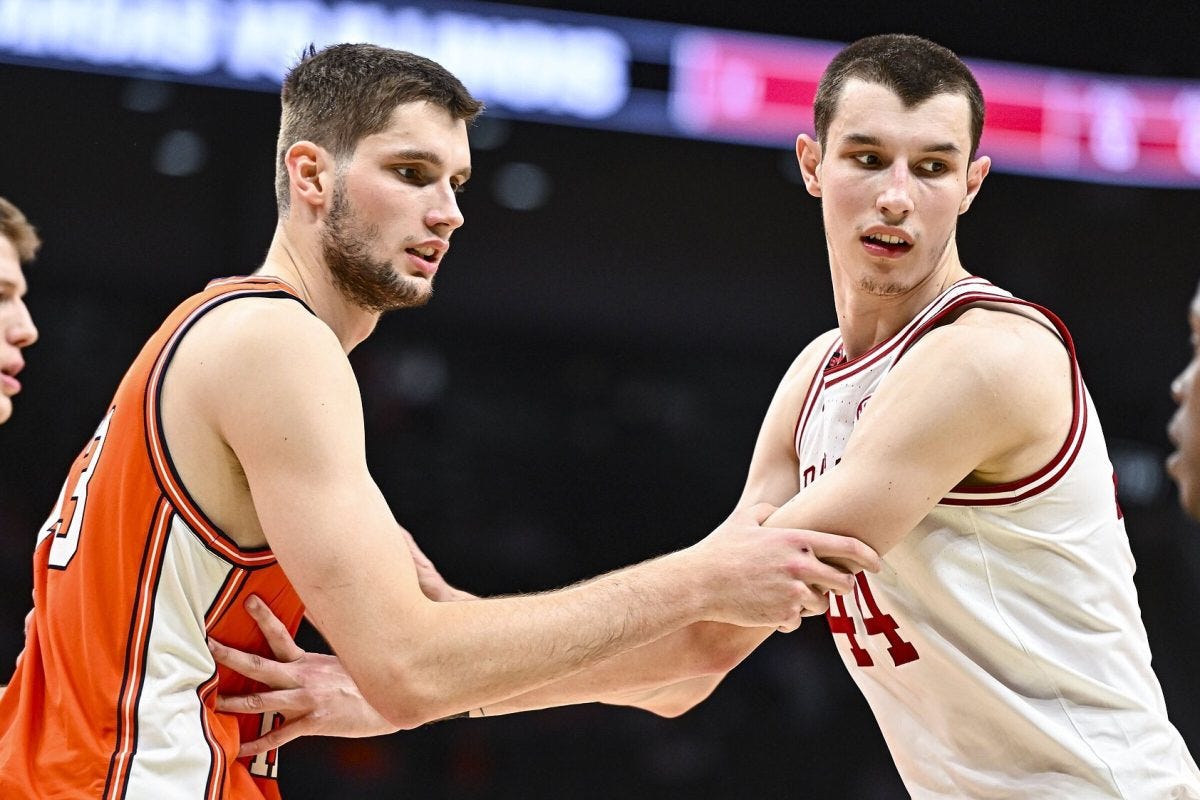 Arkansas forward Zvonimir Ivisic (right) and his brother, Illinois center Tomislav Ivisic, guard one another during the second half of the No. 19 Razorbacks’ 90-77 loss to the Fighting Illini on Thursday at the Thanksgiving Hoops Showcase in Kansas City, Missouri.
