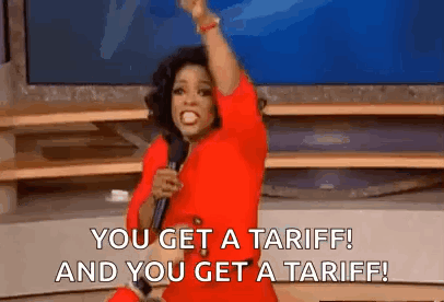 a woman in a red dress is holding a microphone and shouting .