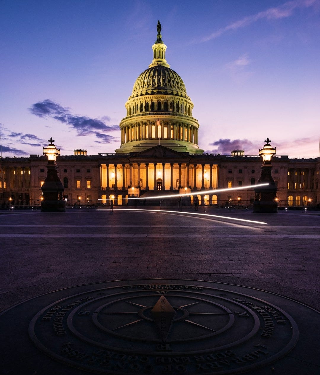 the capitol building is lit up at night