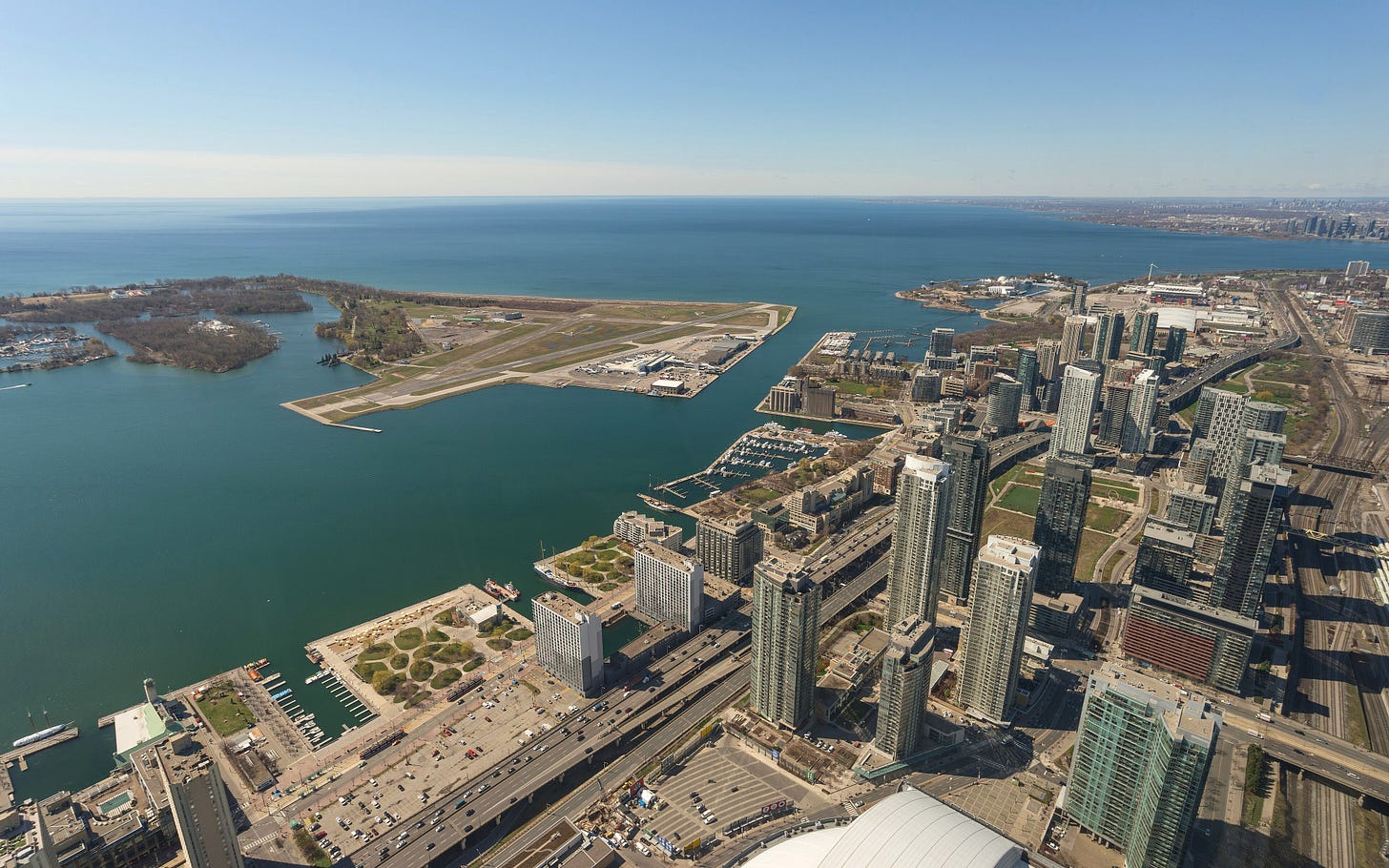 Aerial view from the CN Tower looking southwest over the Toronto waterfront, with Billy Bishop Toronto City Airport's runway visible on the Toronto Islands and Hanlan's Point visible as the green landmass to the airport's left. Aerial view from the CN Tower looking southwest over the Toronto waterfront, with Billy Bishop Toronto City Airport's runway visible on the Toronto Islands and Hanlan's Point visible as the green landmass to the airport's left.