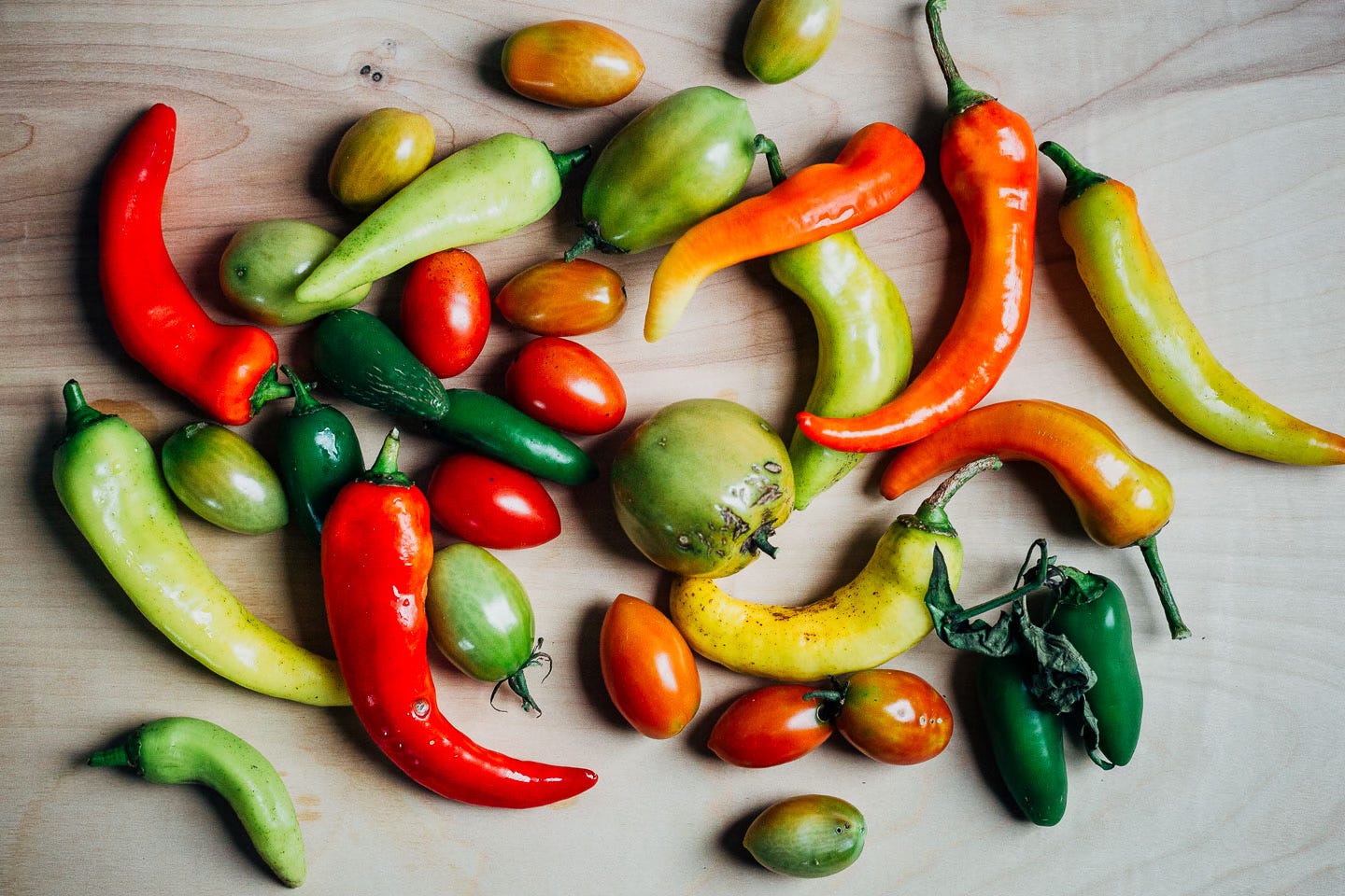 Green and ripe peppers and tomatoes