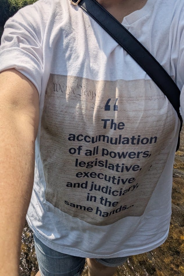 Beginning of James Madison quote on t-shirt background of U.S. Constitution: "The accumulation of all powers, legislative, executive, and judicial, in the same hands..."