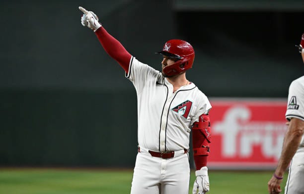 Christian Walker of the Arizona Diamondbacks gestures to his dugout after hitting an RBI single against the San Francisco Giants during the fourth...