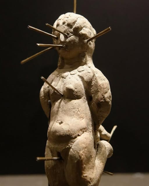 World Archaeology - Female doll in kneeling position, pierced with ...