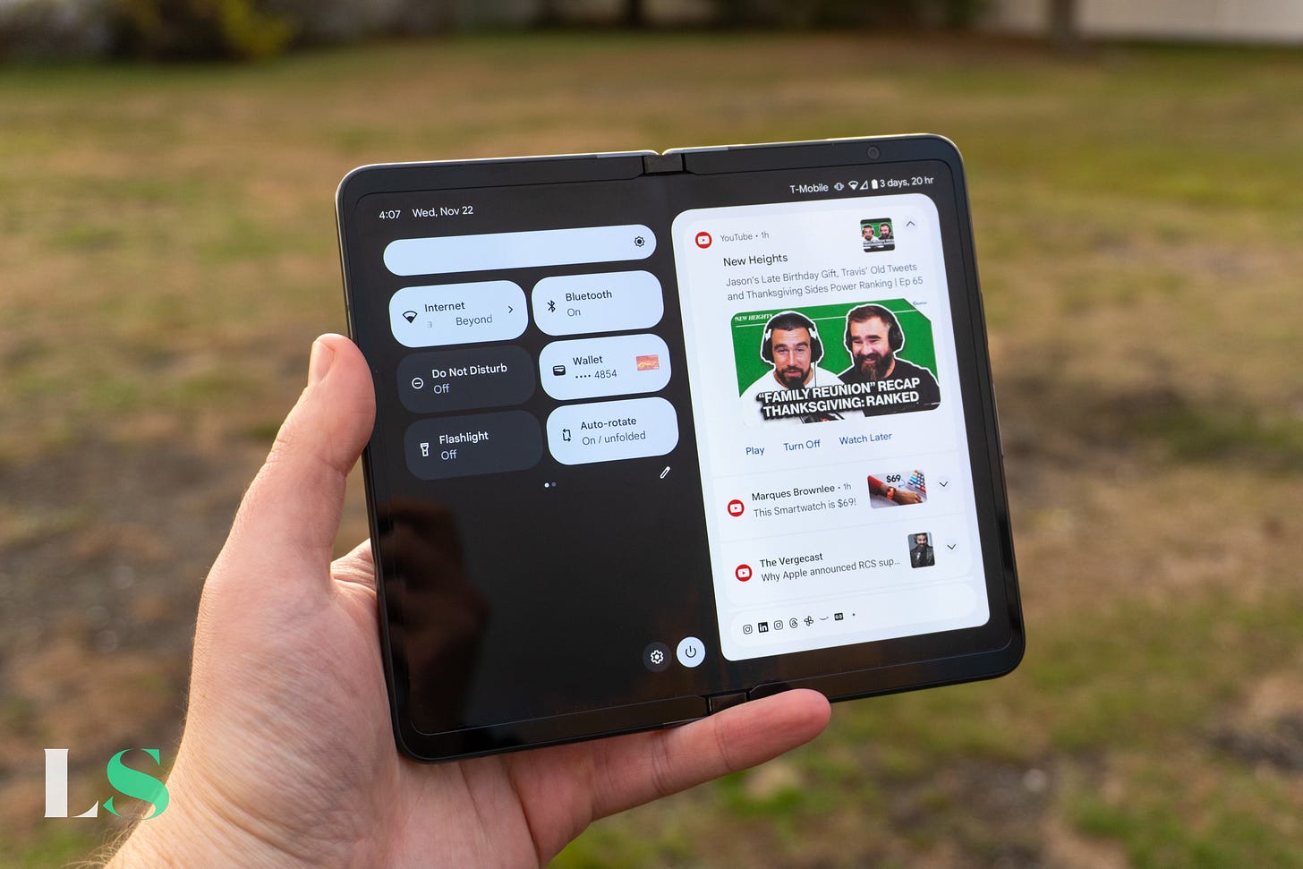 Google Pixel Fold quick settings panel with New Heights Travis Kelce Jason Kelce YouTube notification.