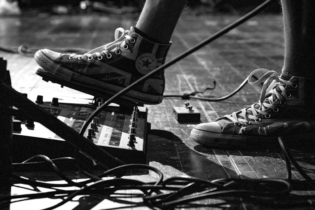 person wearing black and white converse all star high top sneakers person wearing black and white converse all star high top sneakers