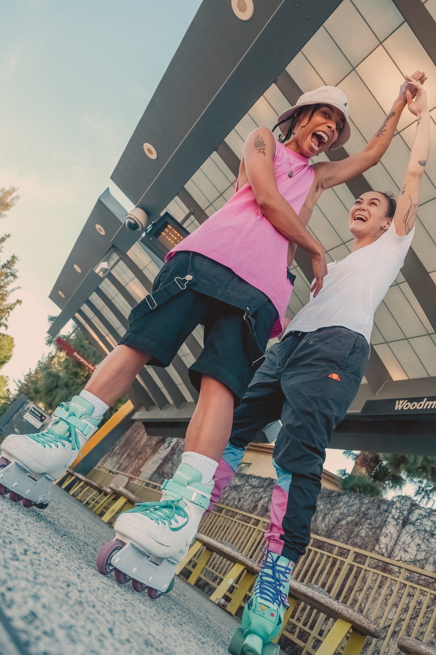 Raw and Issa twirling each other around while rollerskating.