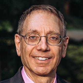 A person wearing glasses and smiling

AI-generated content may be incorrect.