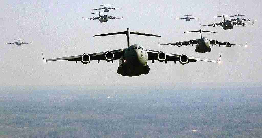 military transport planes flying in formation