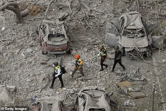 BEER SHEVA, ISRAEL - JUNE 24: Emergency and rescue responders work  at the rubble of a building after a ballistic missile fired from Iran strike a building at the city on June 24, 2025 in Beer Sheva, Israel. Iran and Israel have continued to exchange aerial attacks in the days after the United States joined the war and bombed several Iranian nuclear sites. (Photo by Amir Levy/Getty Images)