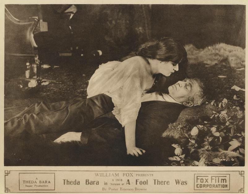 Promotional photo for the 1915 film “A Fool There Was” features Theda Bara and costar Edward Jose. They recreate the pose from Philip Burne-Jones’ 1897 painting, “The Vampire.” Bara gazes down triumphantly at the man’s unconscious body. Promotional photo for the 1915 film “A Fool There Was” features Theda Bara and costar Edward Jose. They recreate the pose from Philip Burne-Jones’ 1897 painting, “The Vampire.” Bara gazes down triumphantly at the man’s unconscious body.