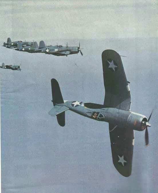 A rare color photo of an early production F4U-1 Corsair performing a 'side slip' maneuver over Guadalcanal in 1943.