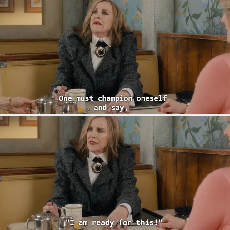 This may contain: two women sitting at a table talking to each other with coffee cups in front of them