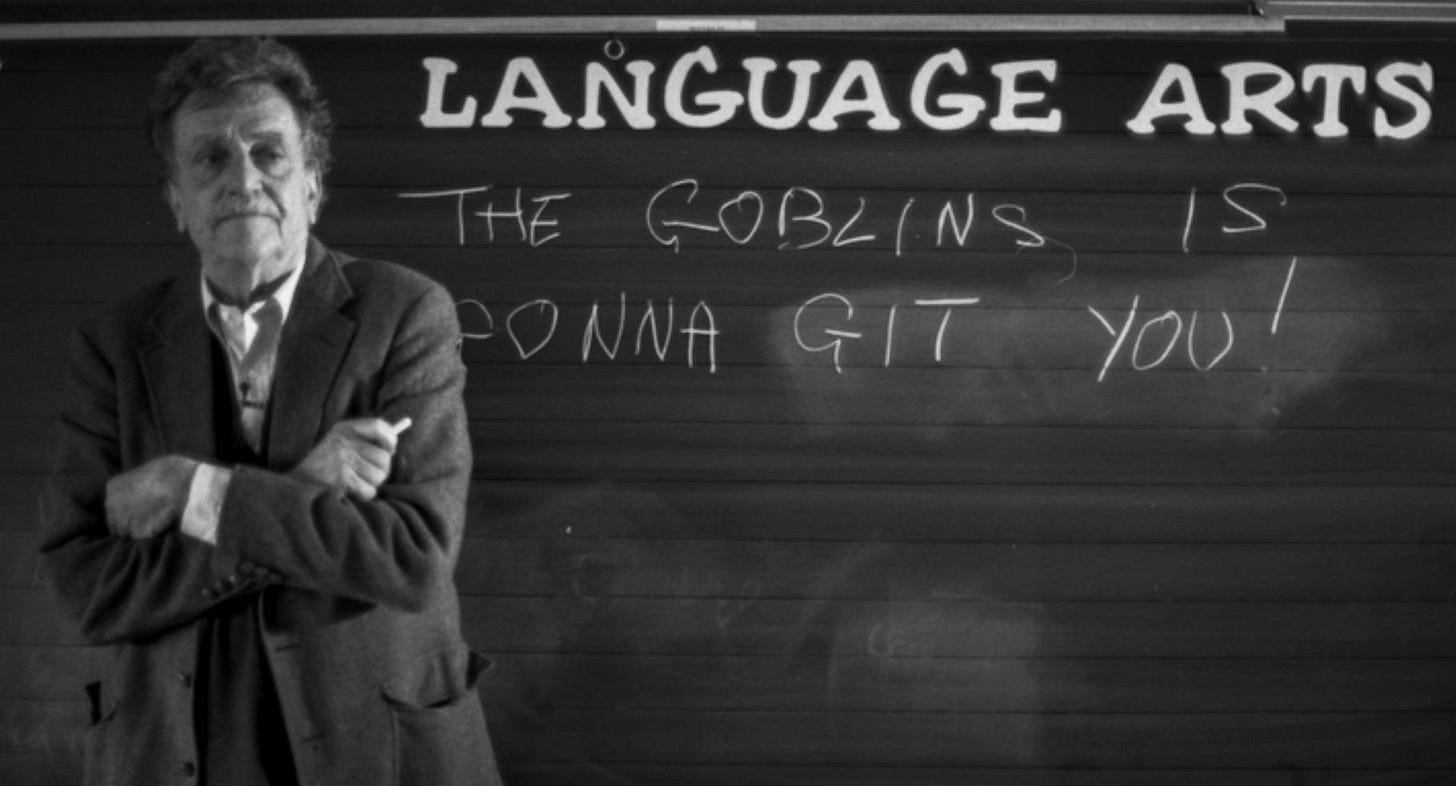 A person standing in front of a blackboard

Description automatically generated