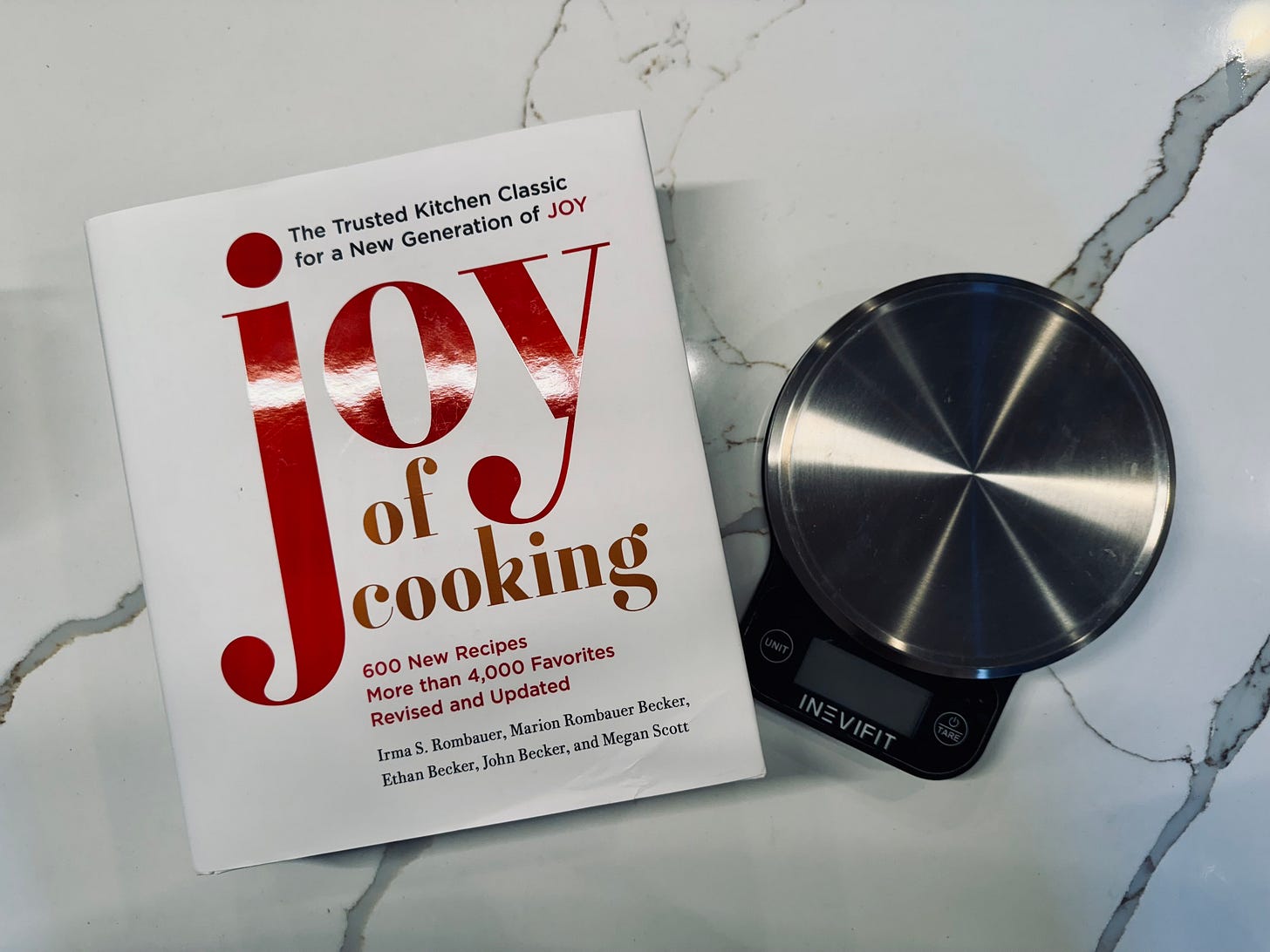 Joy of cooking, cookbook on counter with a digital scale