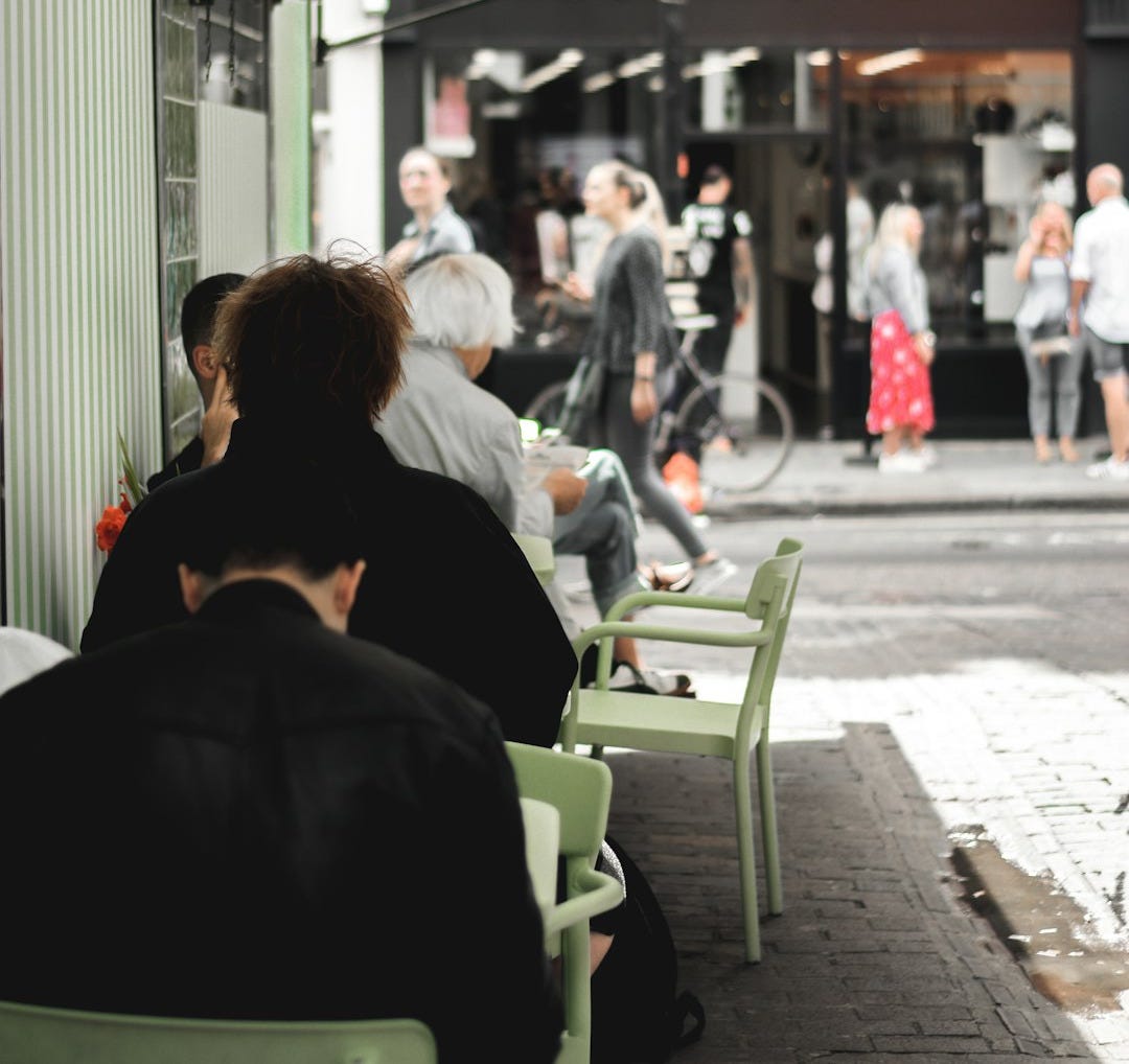 group of people near brown building