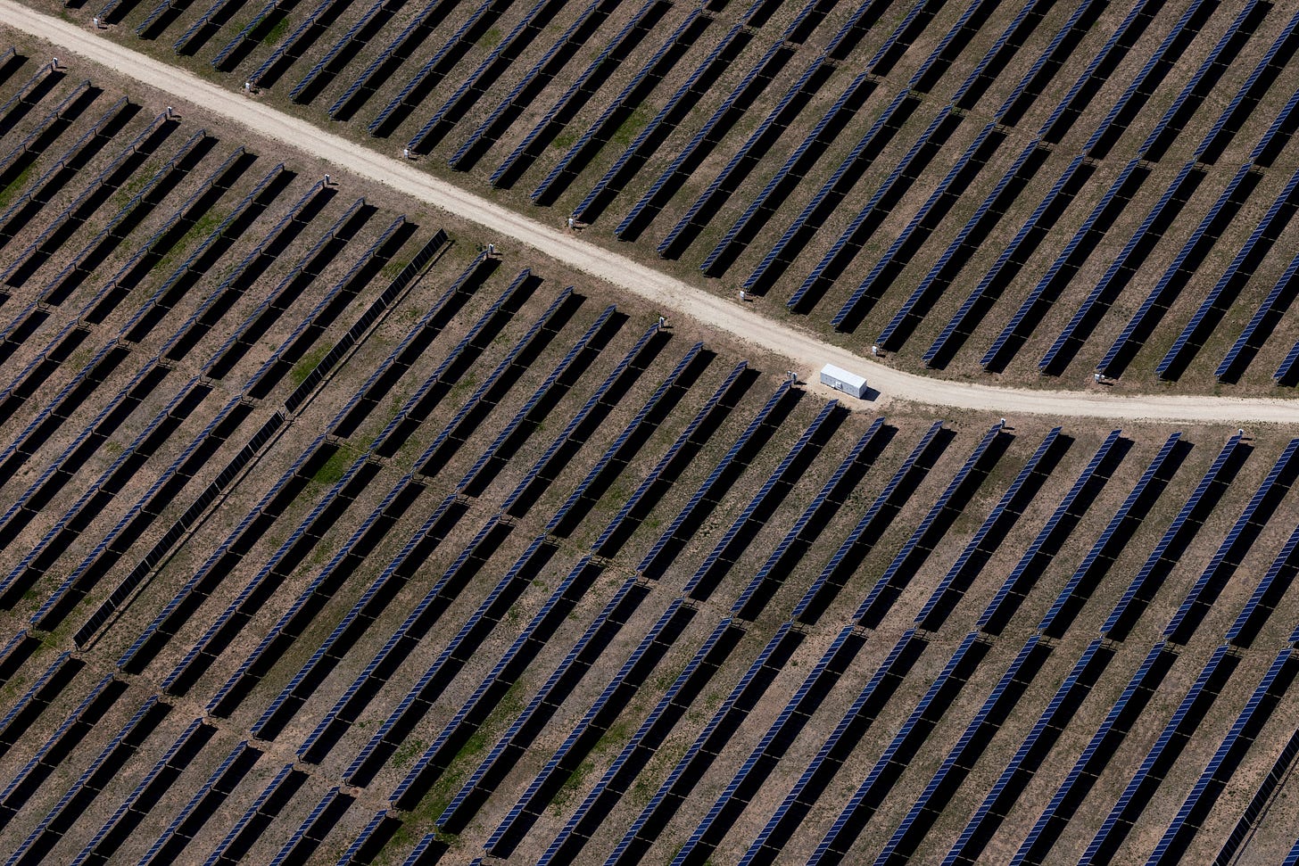 An aerial view shows rows of solar panels at a solar farm in Anson, Texas