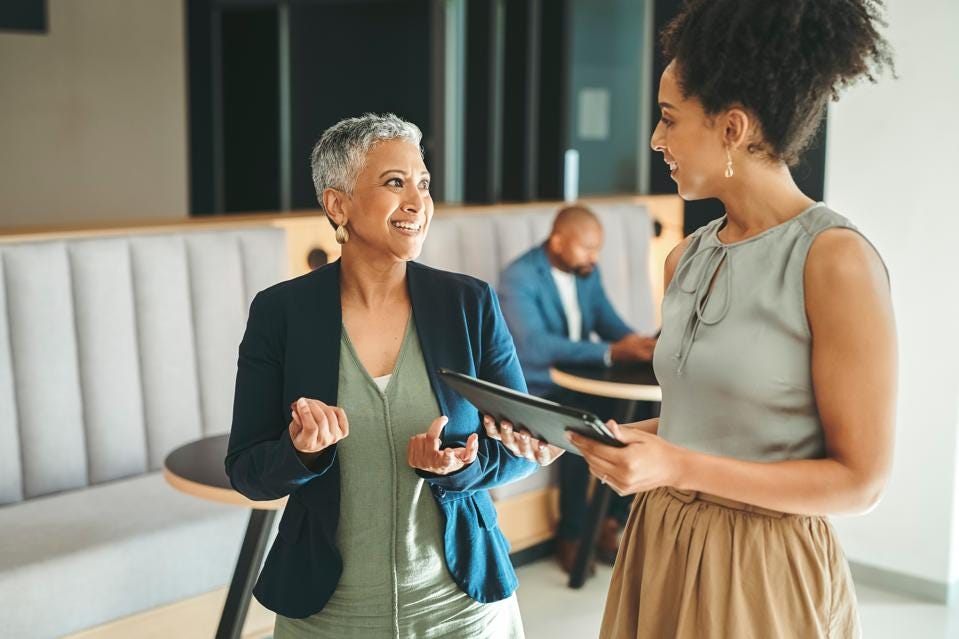 Two business women meeting in the work lobby. 