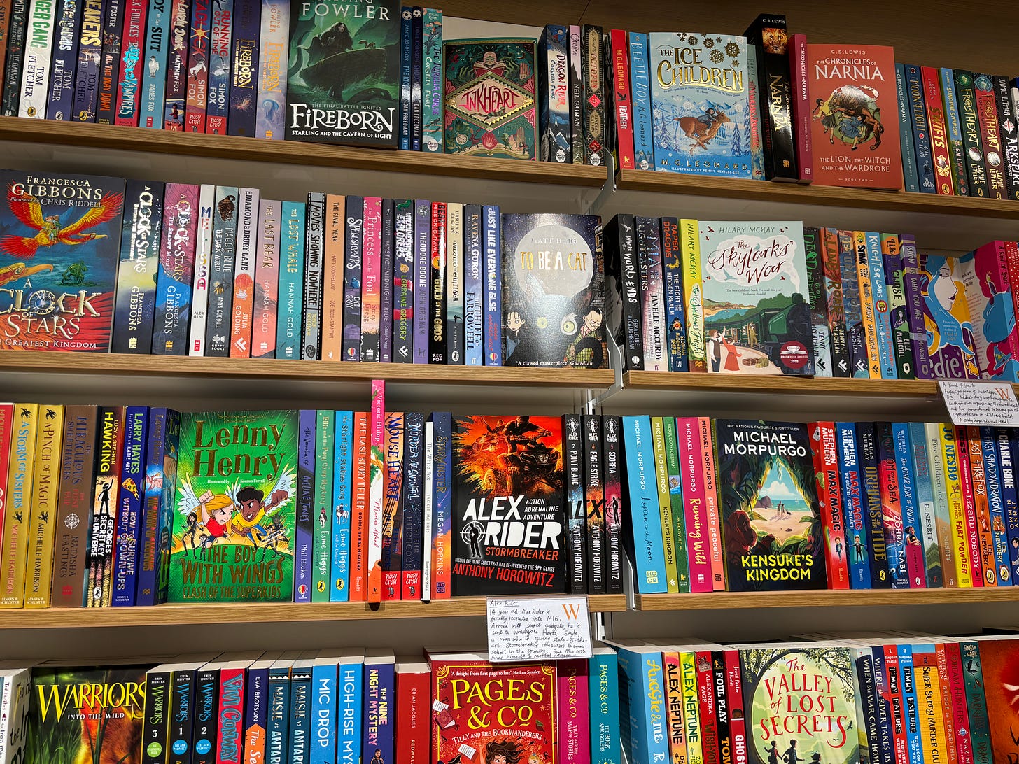 A large bookshelf covered in multicolored middle grade books.