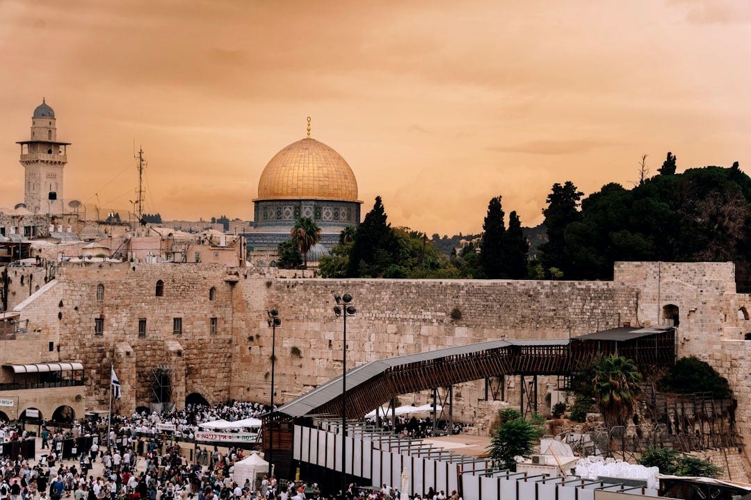 a crowd of people standing in front of a building a crowd of people standing in front of a building