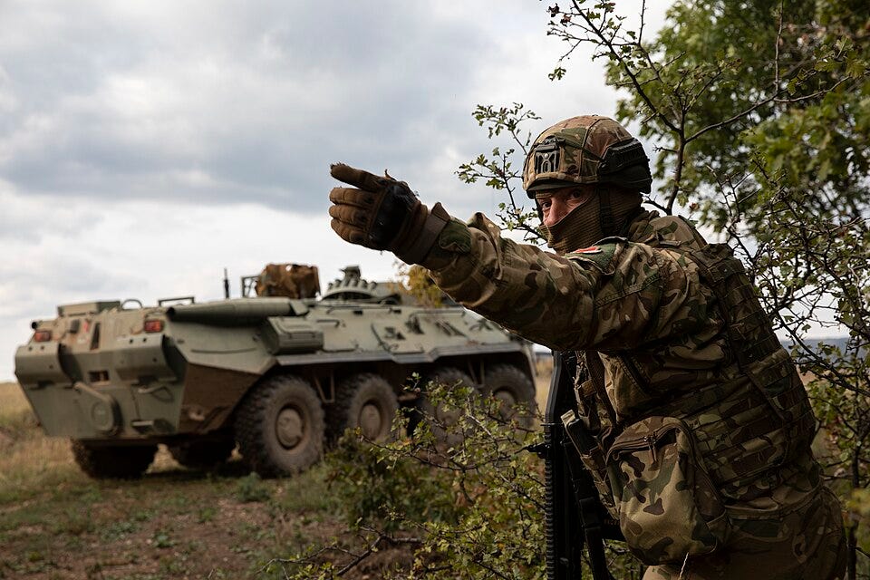 A Hungarian soldier gestures to troops during Exercise Brave Warrior 2022 at the Hungarian Defence Forces Central Training Area in Bakony, Hungary. A Hungarian soldier gestures to troops during Exercise Brave Warrior 2022 at the Hungarian Defence Forces Central Training Area in Bakony, Hungary.