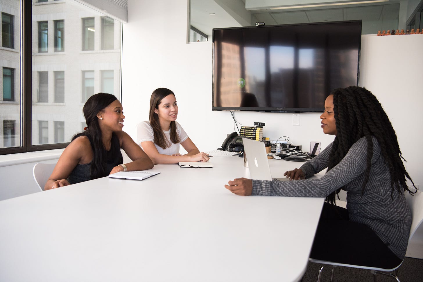 Image of three women sitting at a conference room table. Are they in an interview? Are they discussing a candidate they just met? Image of three women sitting at a conference room table. Are they in an interview? Are they discussing a candidate they just met?