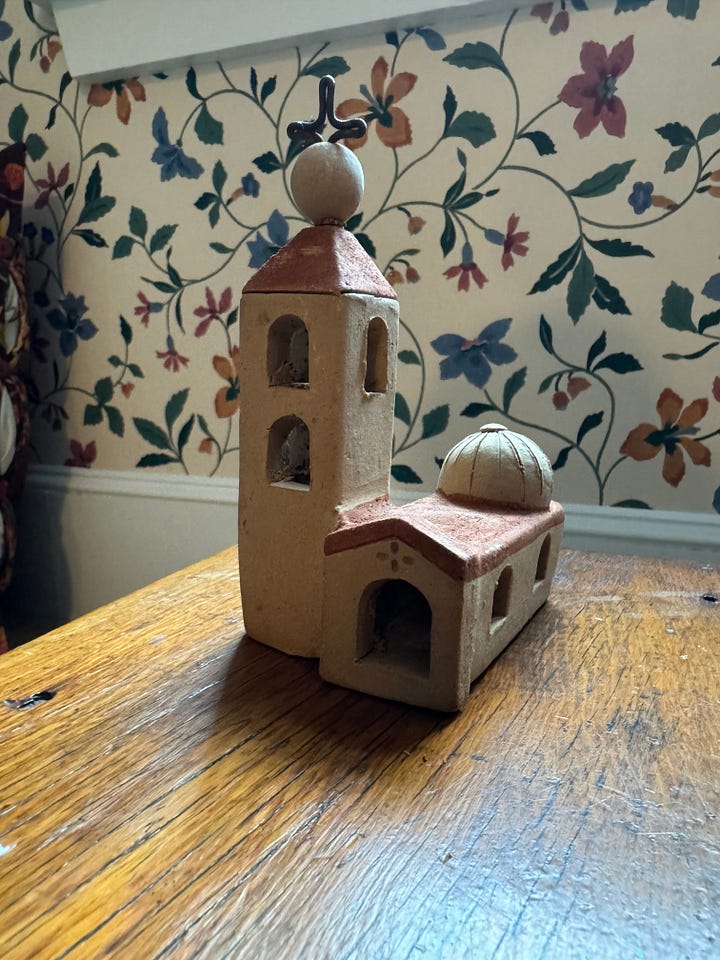 Two photos of a small church made out of clay sitting on a wooden bench.