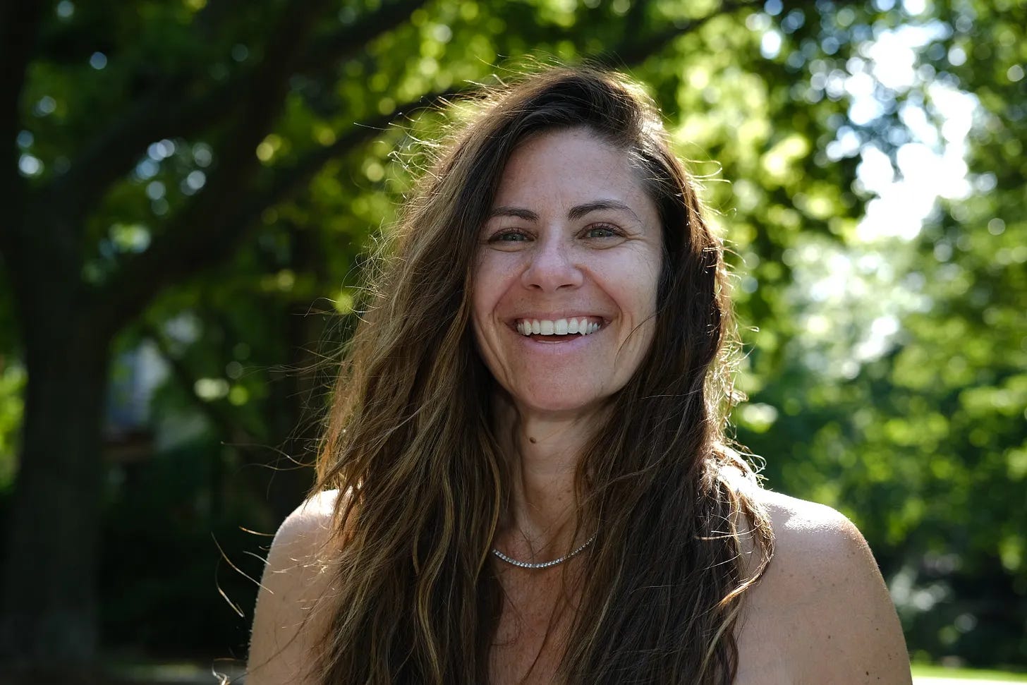 Photo of Christina Nikols, Energy Healer, smiling happy in the park shining in the sunshine Photo of Christina Nikols, Energy Healer, smiling happy in the park shining in the sunshine